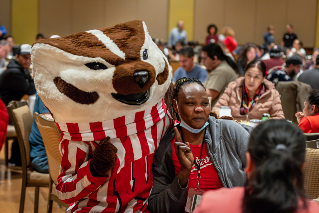 A person poses for a photo with Bucky.