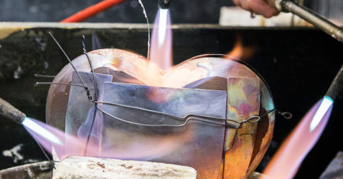 A torch is applied to a piece of metal.