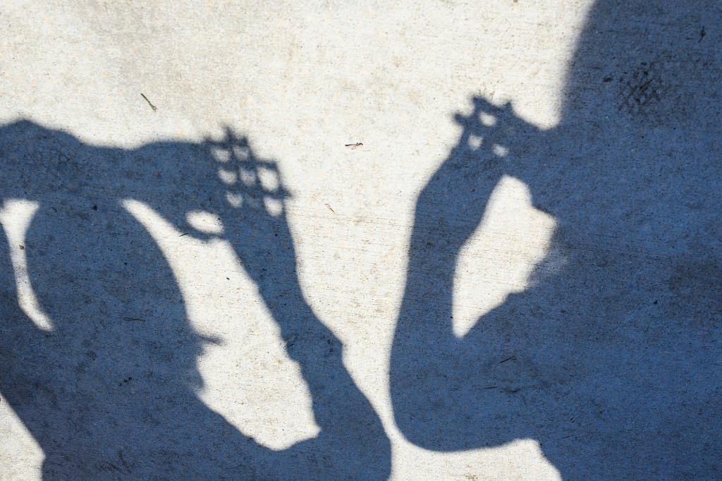 A photograph of the shadow of some hands.