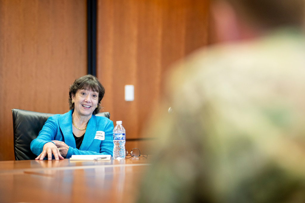 Monica Bertagnolli sits at a conference table and smiles as she speaks.