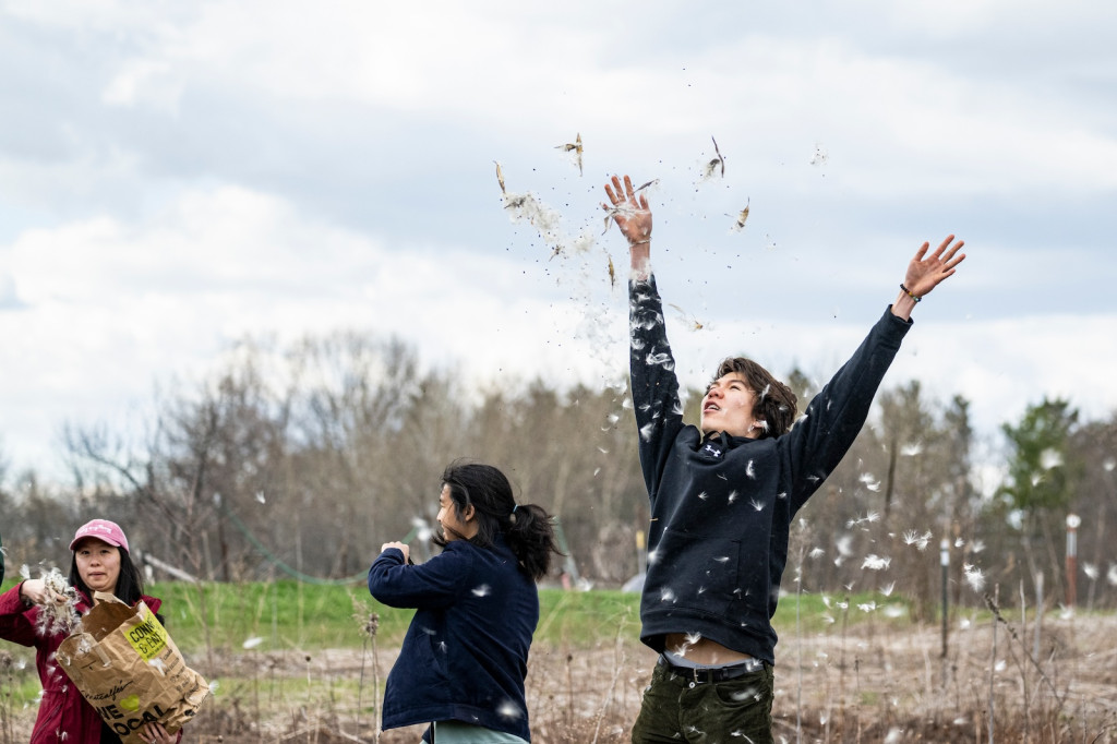 Two students are shown throwing seeds.