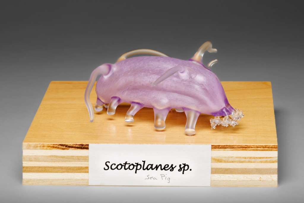 A pink glass model of a pig-like creature.