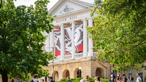 Students and pedestrians walk along Bascom Hill near Bascom Hall between class periods on a late summer day.