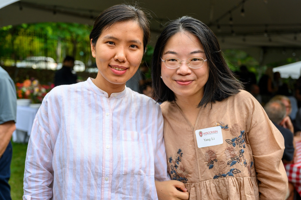 Two women pose for a photo and smile.