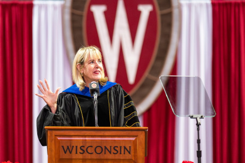 A woman speaks at a poidium.