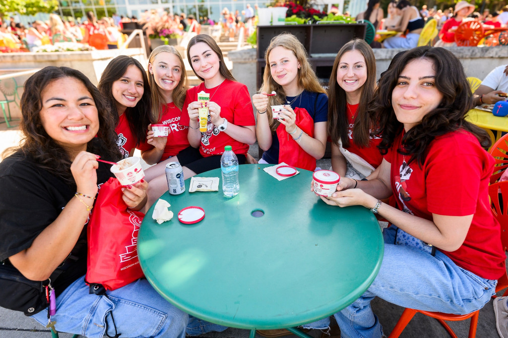 A group of students gather around a table.