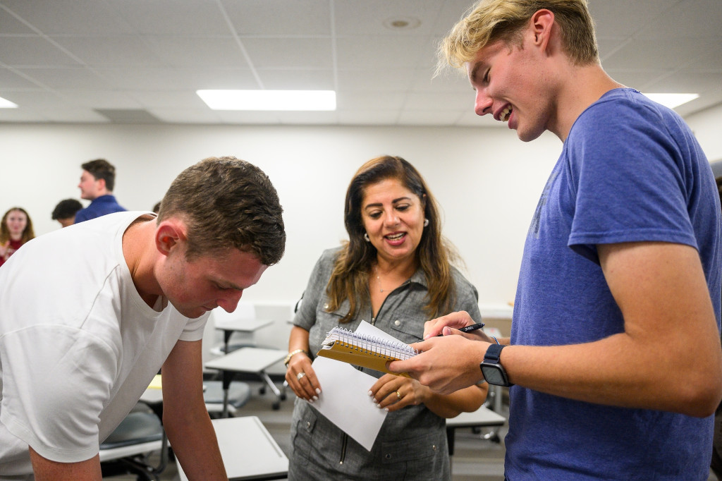 Several students talk and laugh.