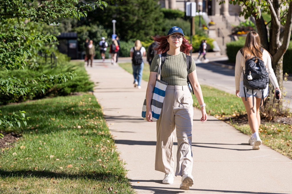 A woman walks up a hill.