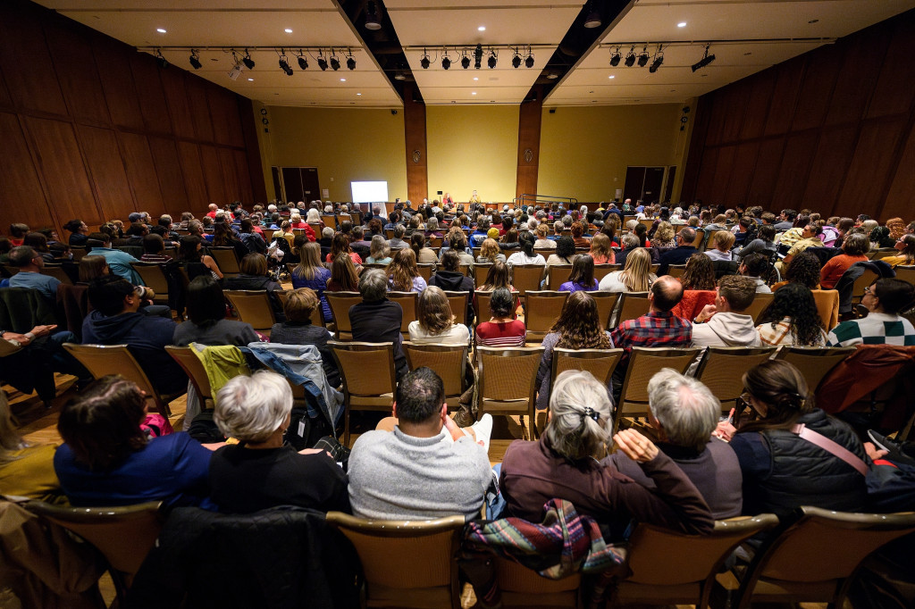 An auditorium packed with people listen to Mnookin and Taussig.