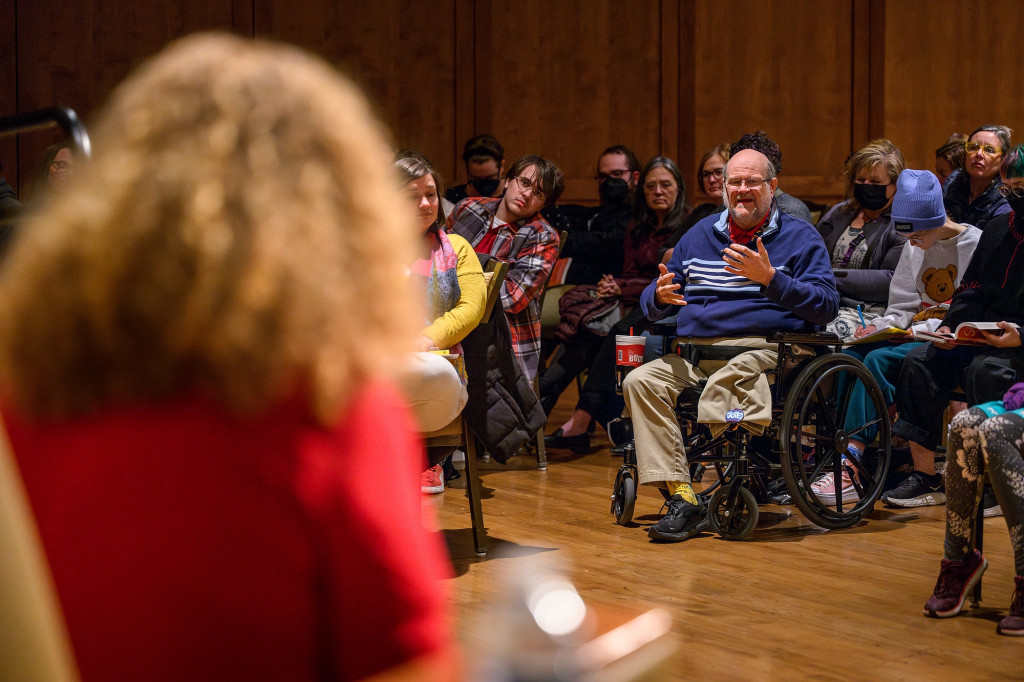 An audience member asks a question of Mnookin and Taussig.