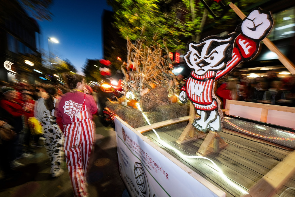 A float has a Bucky Badger cutout and several laser-type lights on it.