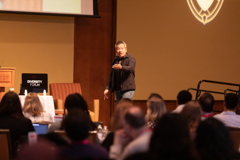 A man speaks to a crowd of people.