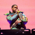 Bad Bunny, wearing a colorful jacket, performs at the Coachella Music & Arts Festival.