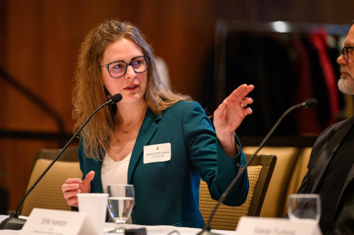 A woman gestures as she speaks.