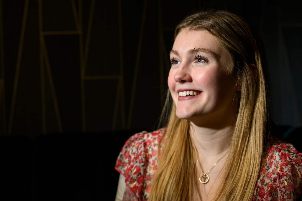 A portrait photo of Brooke Brennan. She looks slightly off camera with her face illuminated against a dark background.