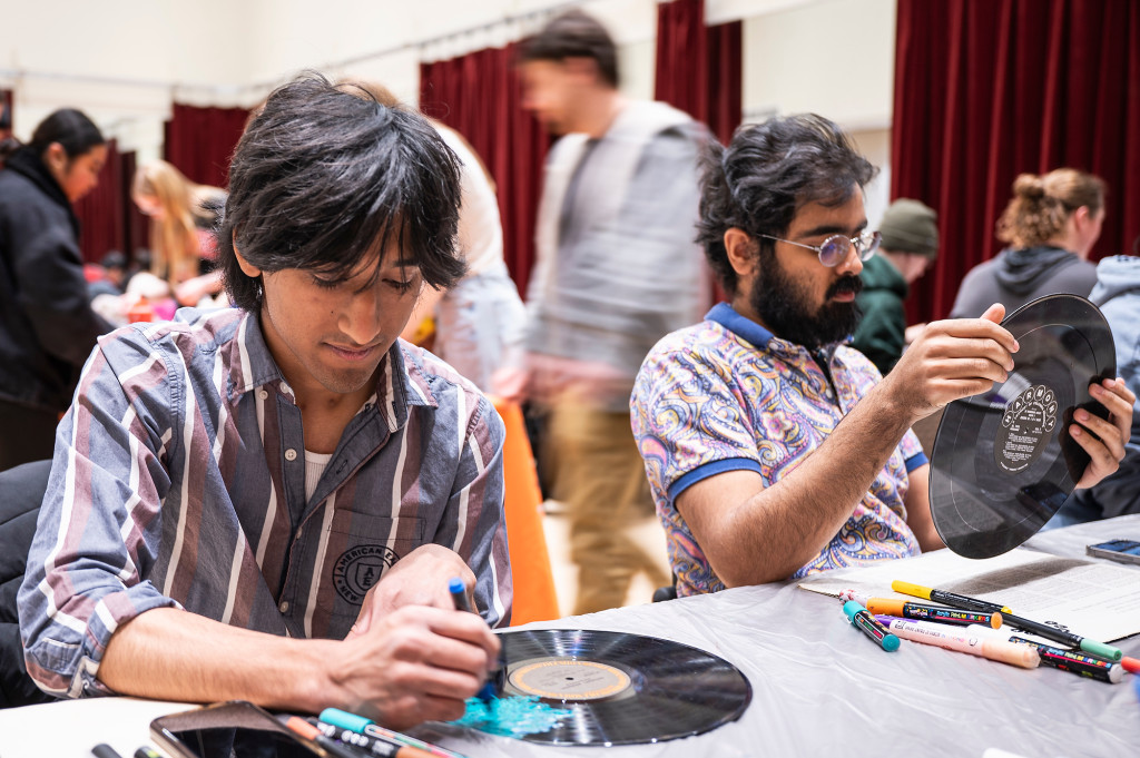 A man draws on a record