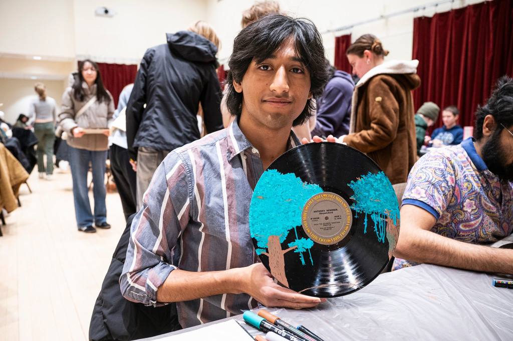 A man shows off a painted record.