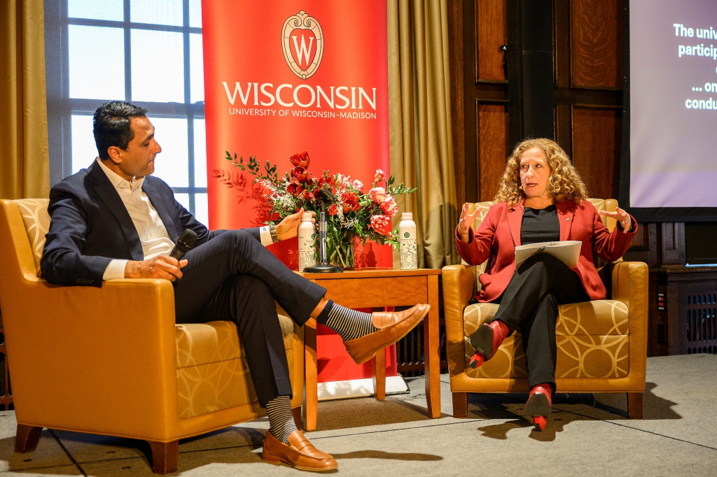 Two people talk on a stage.