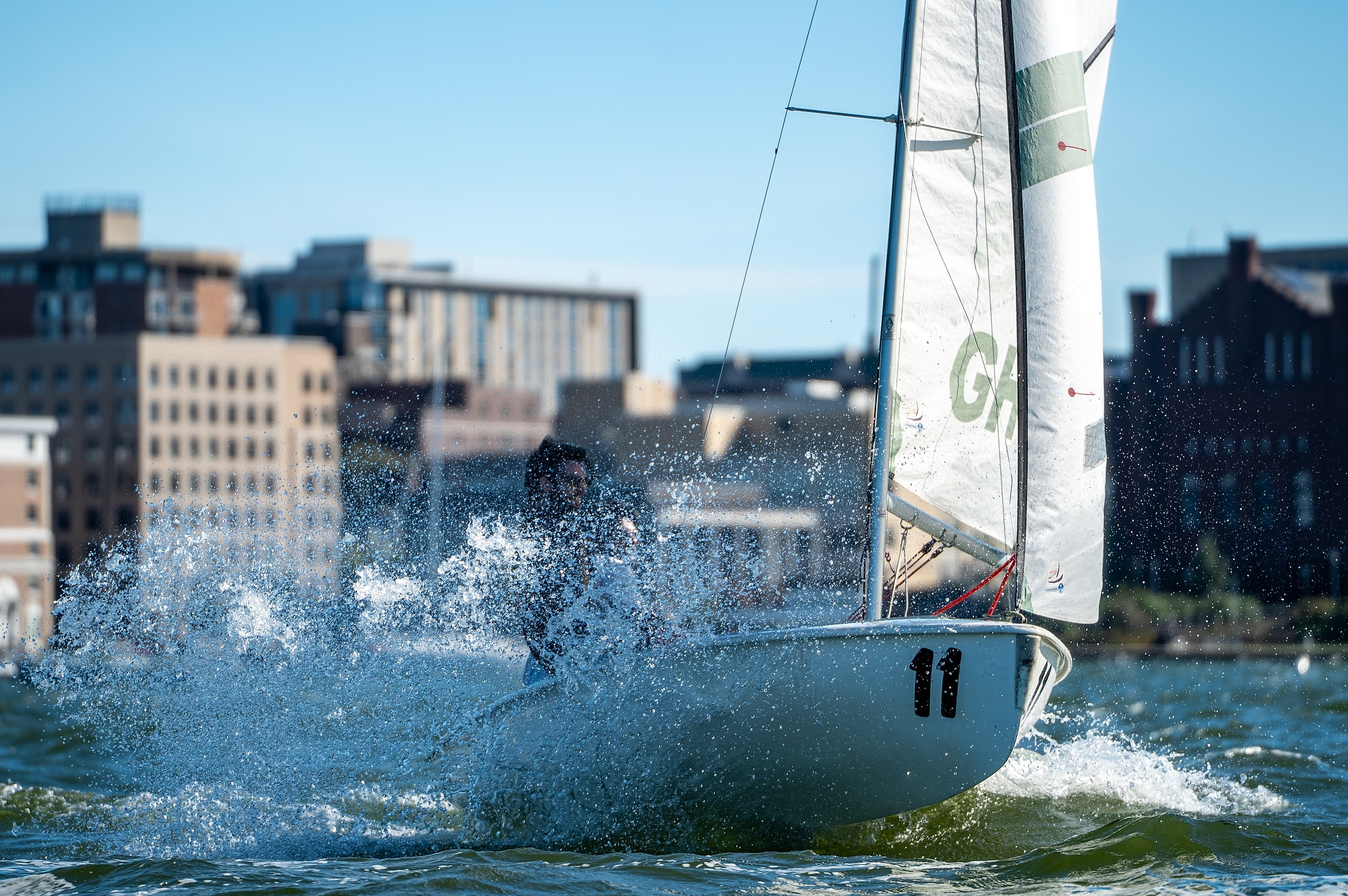 A sailboat splashes through the water.