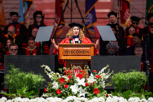 Chancellor Mnookin speaks at a podium and gestures with her hands while looking out at the crowd.
