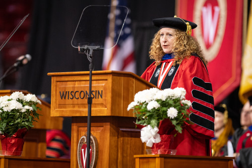 A woman at the podium speaks.