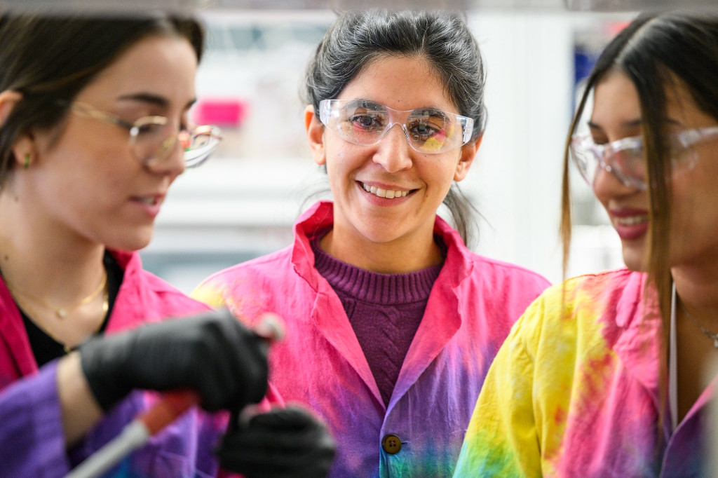 Three people work together in a laboratory.