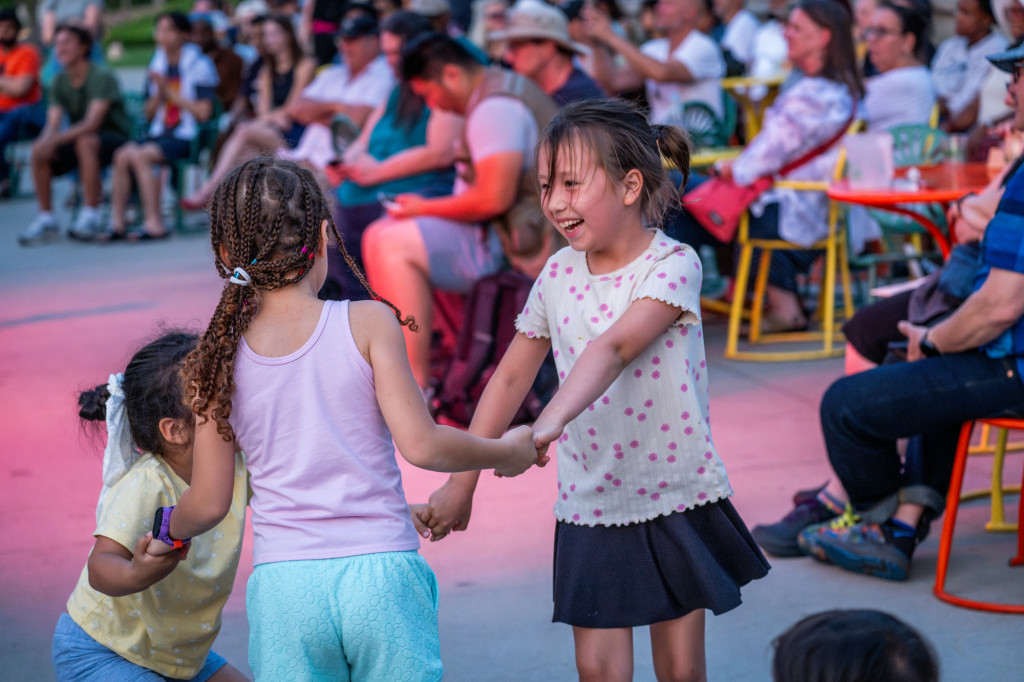 Two children dance on a terrace.