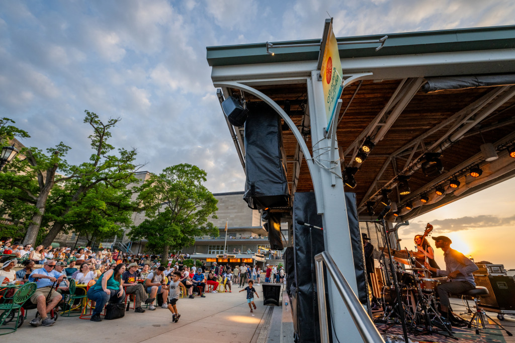 A band is pictured performing on a terrace.