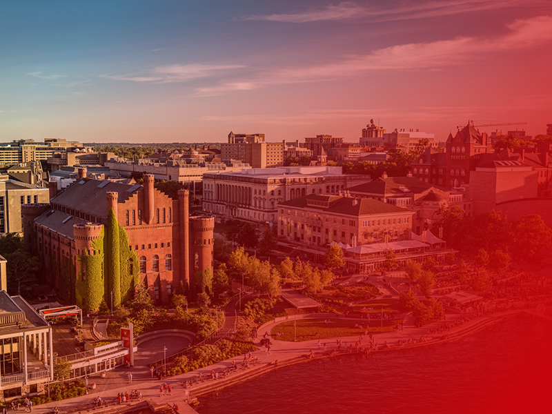 Aerial photo of the Red Gym, Memorial Union and the Lake Mendota shoreline with a transparent red gradient overlaid on the image