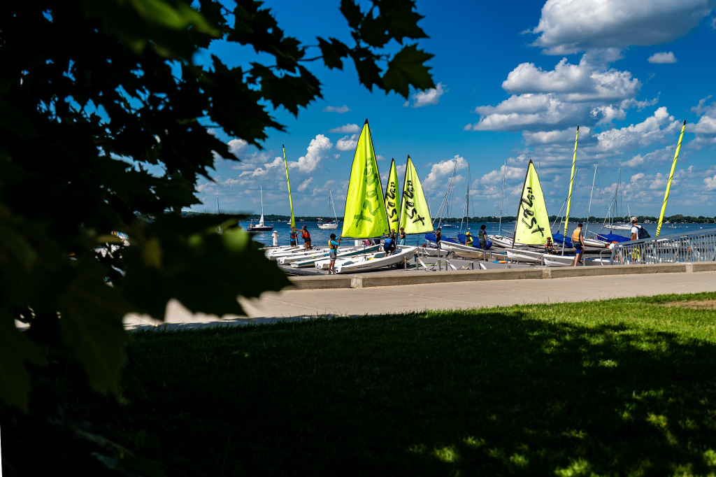 On the T-dock of Tong Family Marina, next to the Hoofers Sailing Club, teenagers sailors rig up Zest sailboats during a sailing summer camp.