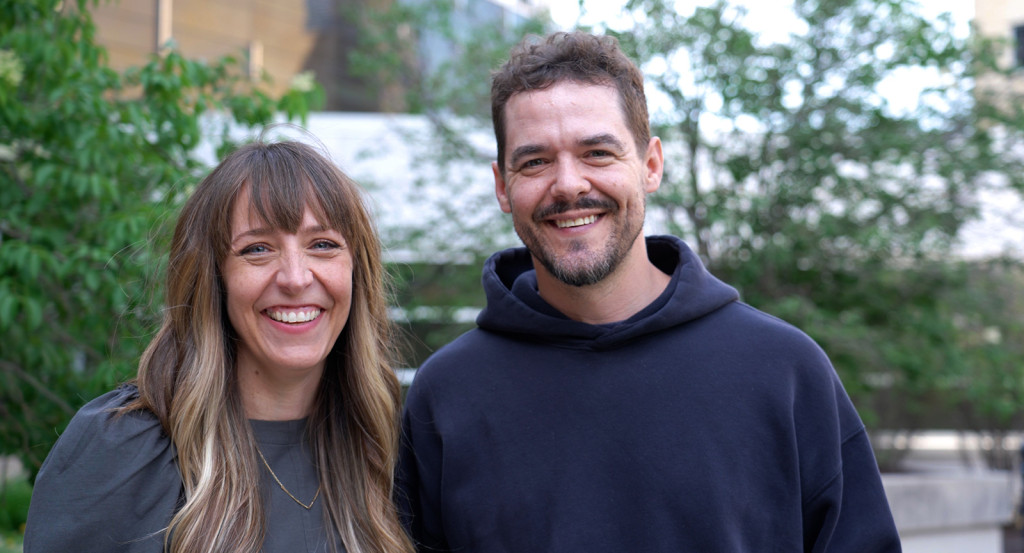 Meagan Hahn and Shawn Wiederhoeft stand together outdoors, smiling.