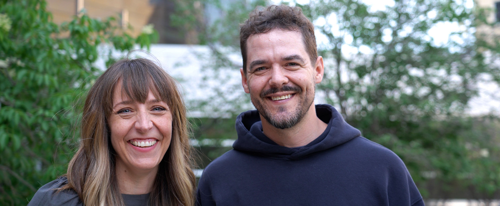 Meagan Hahn and Shawn Wiederhoeft stand together outdoors, smiling.