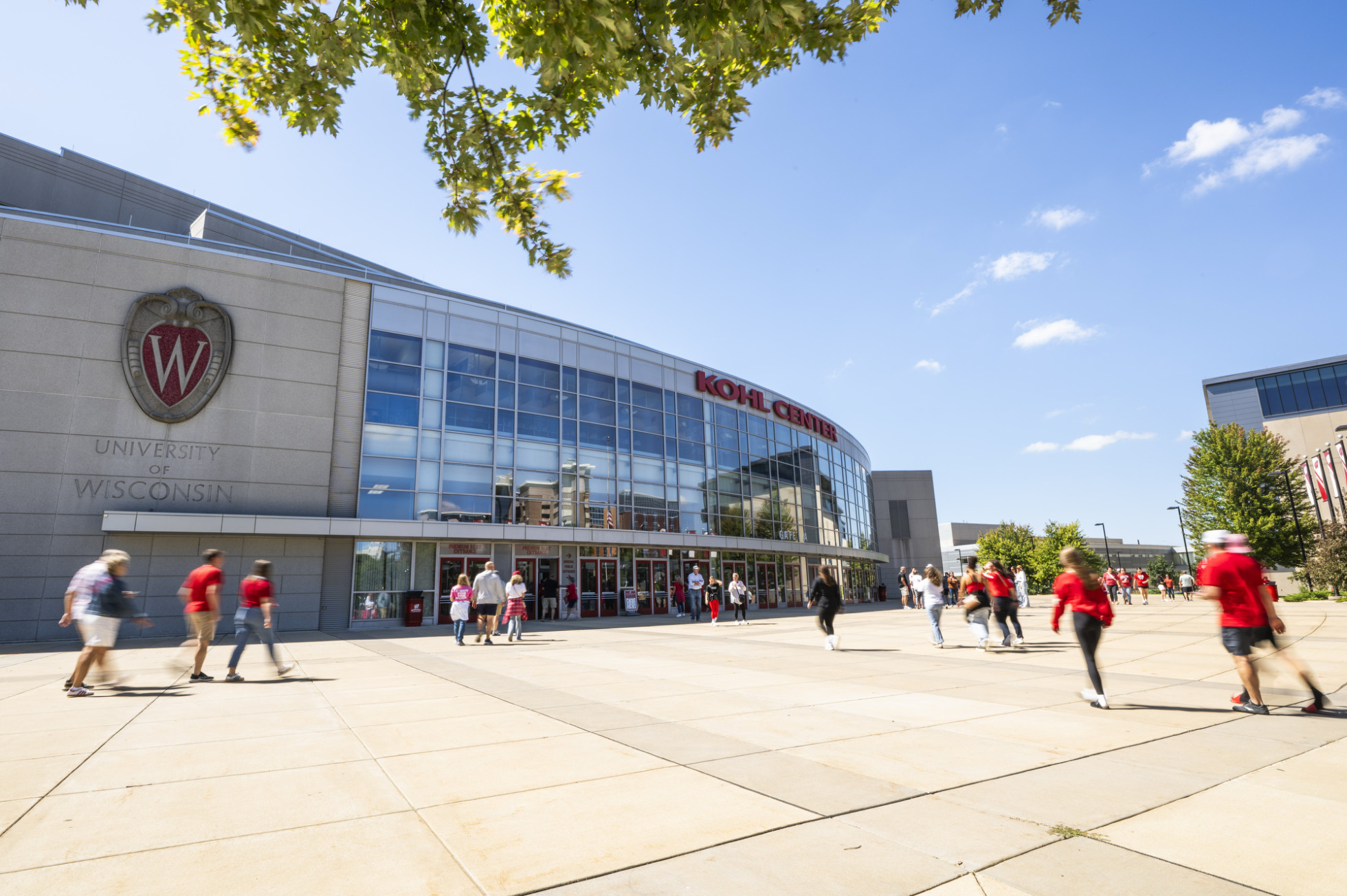 An exterior shot of the Kohl Center show fans walking into the building