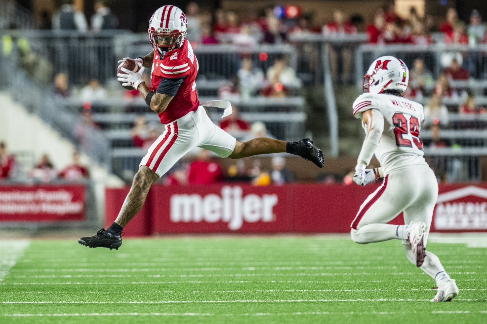 Wide receiver Trech Kekahuna, wearing number 2, makes a leaping catch on the field. 