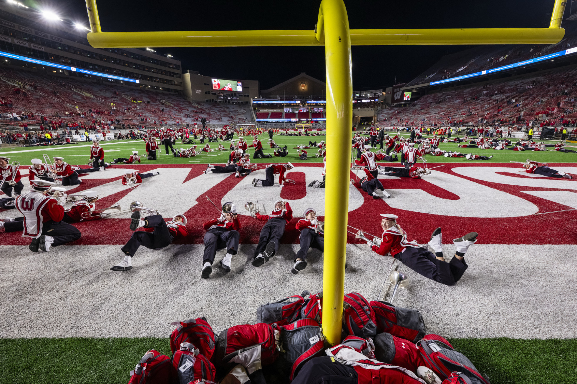 UW Marching Band members lie down in the end zone during their Fifth Quarter performance.