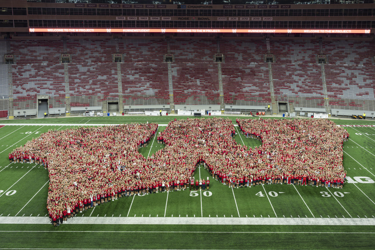 Students form a W on a football field.