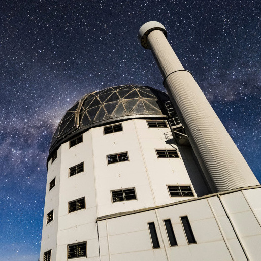 SALT observatory seen from the ground looking up against a starry sky