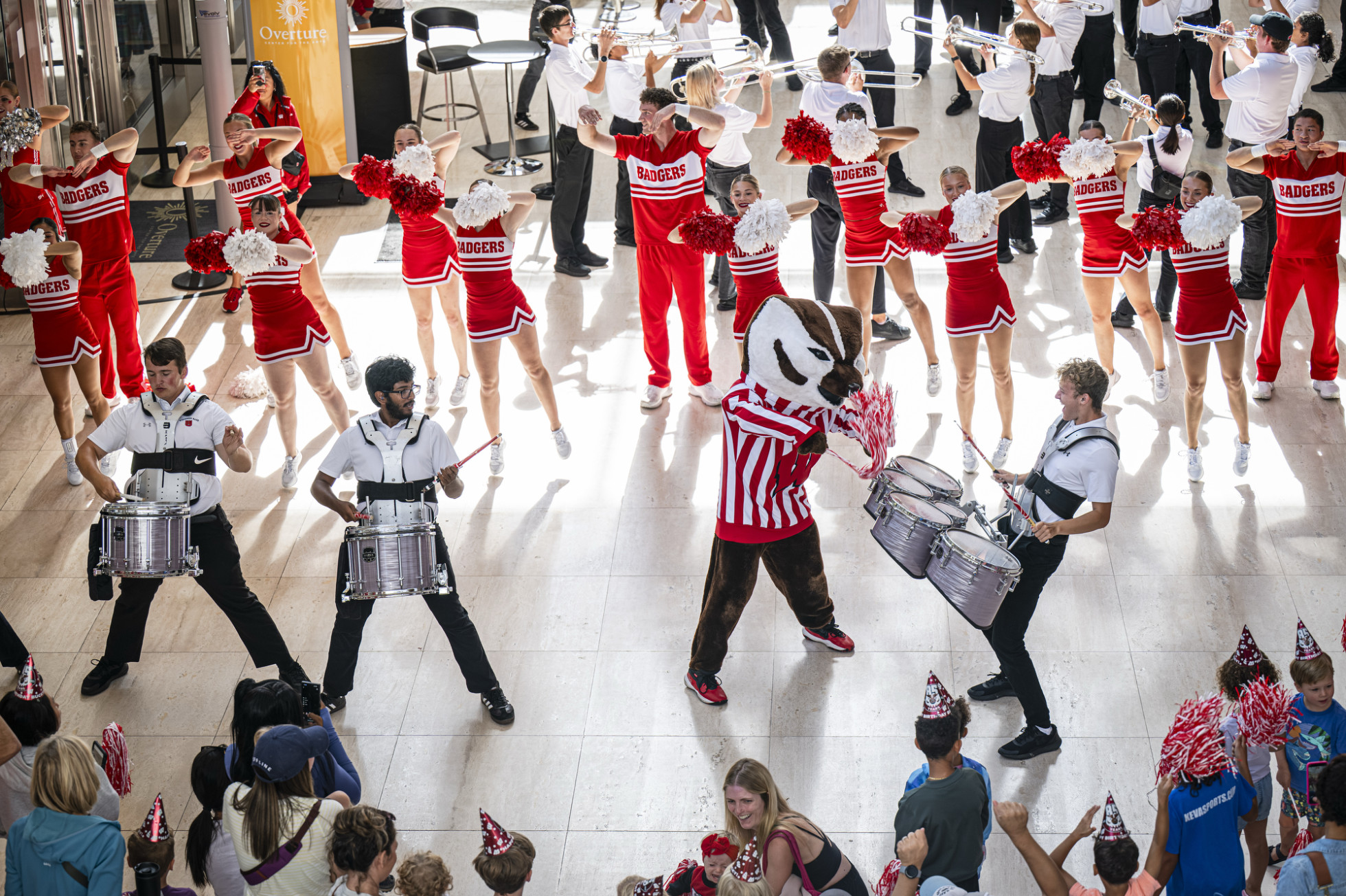 Bucky Badger participates with the UW Marching Band drummers and Spirit Squad performance inside the Overture Center. 