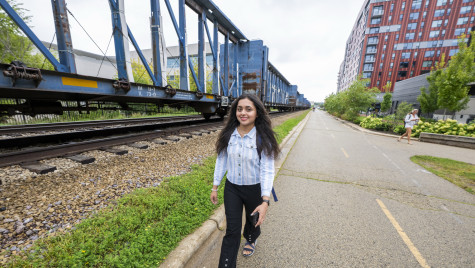 Lakadia walks outside on a bike bath that runs along a railroad track.