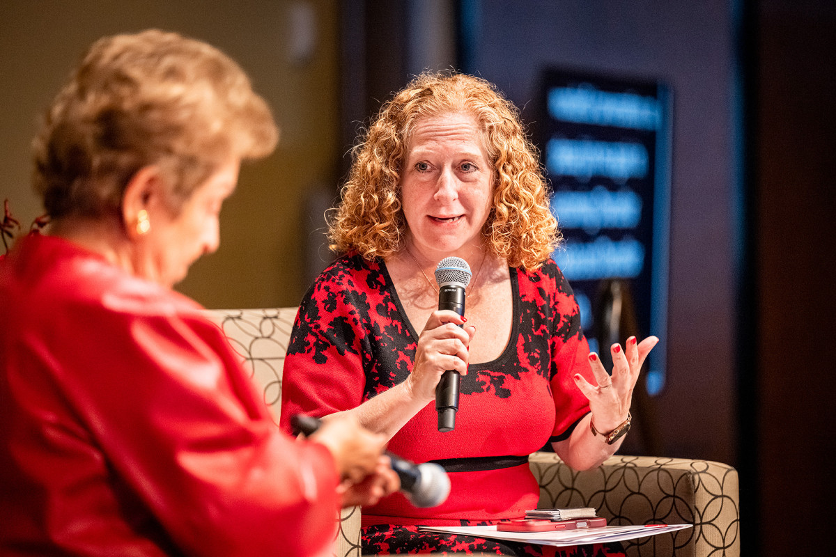 Mnookin speaks into a microphone with Shalala to the left.