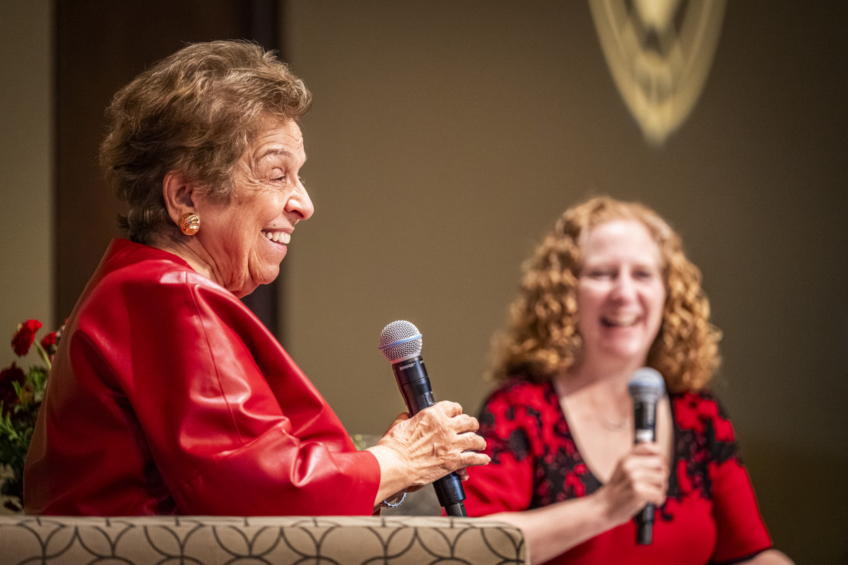 Slalala speaks into a microphone with Chancellor Mnookin to the right.