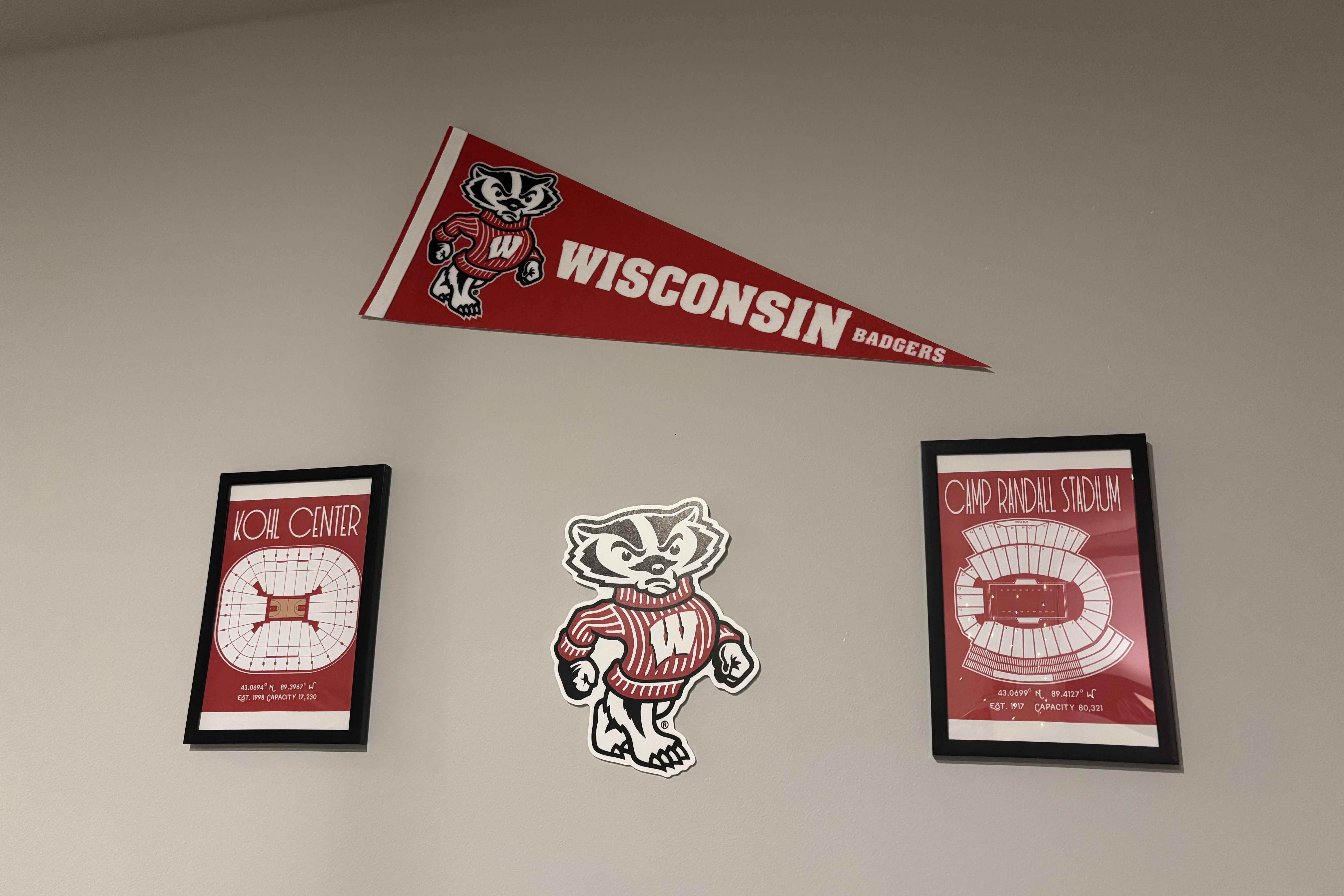 Some Badger-themed banners and posters hang on a wall.