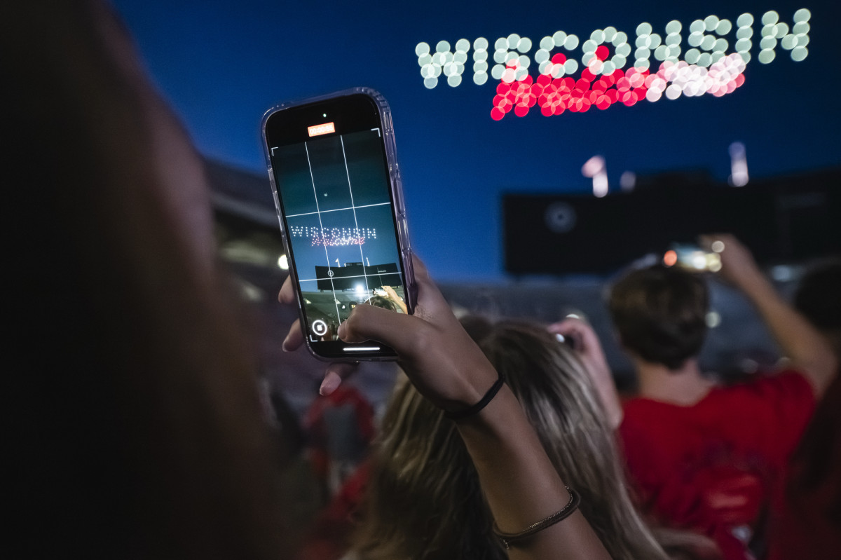A student takes a video of the light show overhead. 