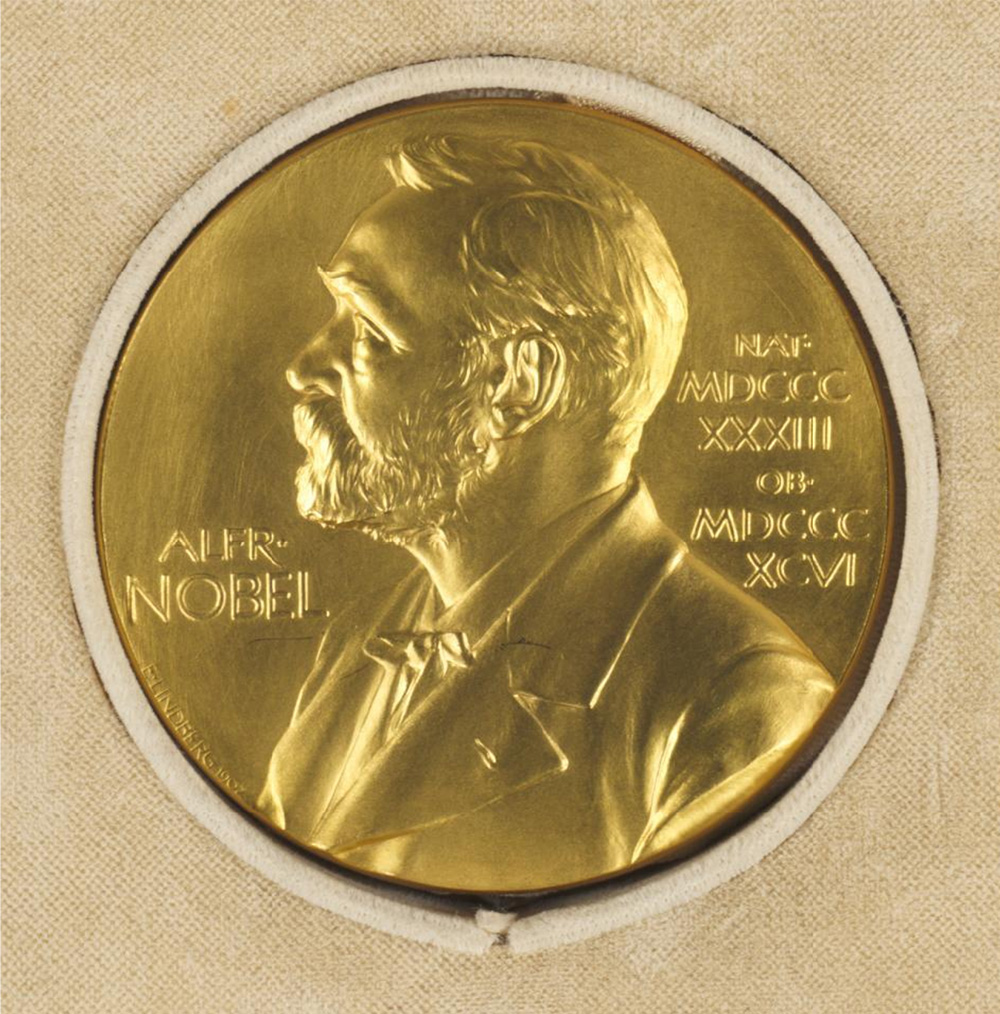 A gold Nobel Prize medal displaying a profile of Alfred Nobel.