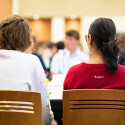 Group of people in conversation around a table
