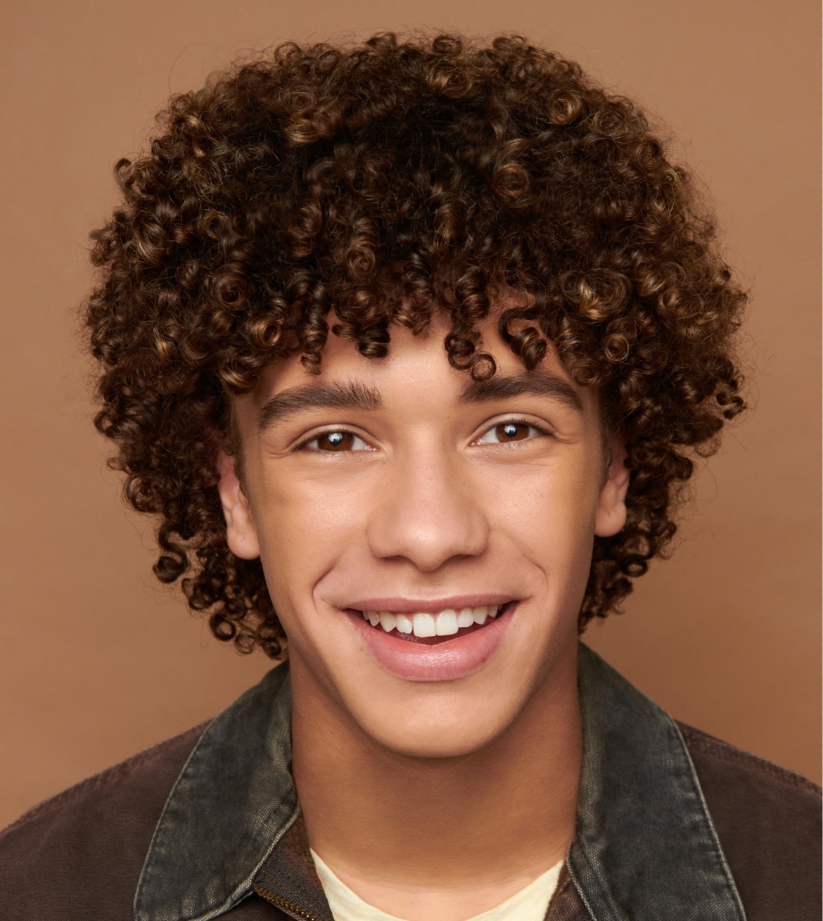 Headshot of Nate Buescher, wearing denim jacket.