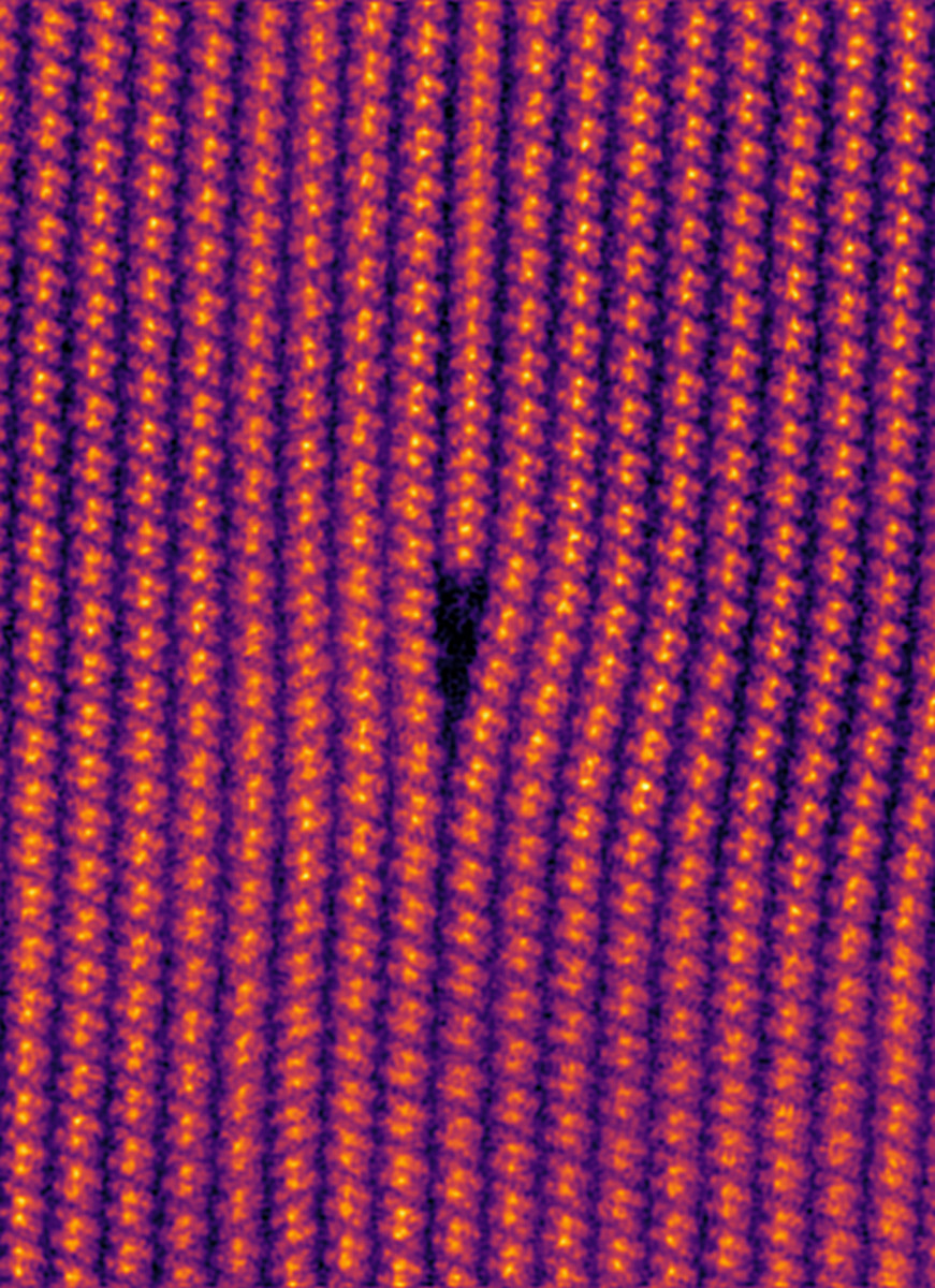 A geometric grid of red, yellow and orange dots against a black background.