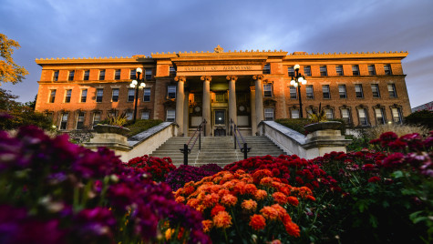 Historic building in the glow of sunlight with flowers in the foreground