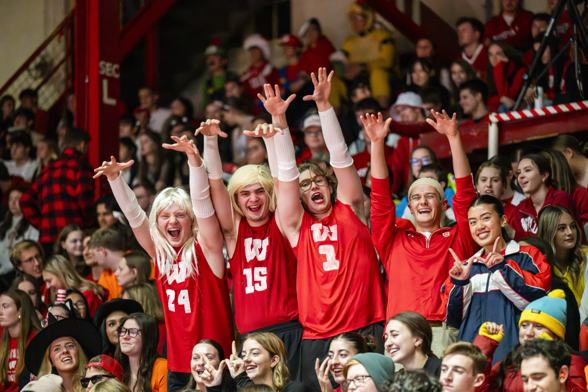 A group of students dressed as Badger volleyball players stand and pose for the camera.