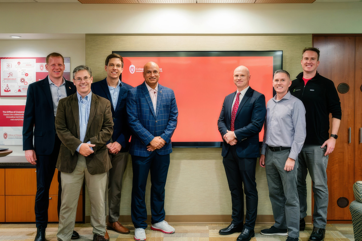 A group that make up some of the founders and faculty in the Badger Tech Foundry stands together to pose for a photo.
